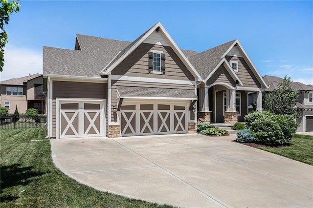 25072 W 114th Ct, Olathe, KS 66061 - craftsman inspired home with driveway, a shingled roof, stone siding, and an attached garage