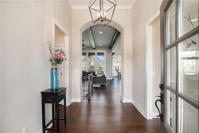 25072 W 114th Ct, Olathe, KS 66061 - entrance foyer with arched walkways, dark wood finished floors, a ceiling fan, a chandelier, and crown molding