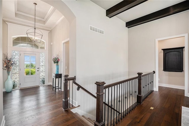 25072 W 114th Ct, Olathe, KS 66061 - foyer entrance featuring wood-type flooring, arched walkways, a chandelier, beamed ceiling, and a towering ceiling
