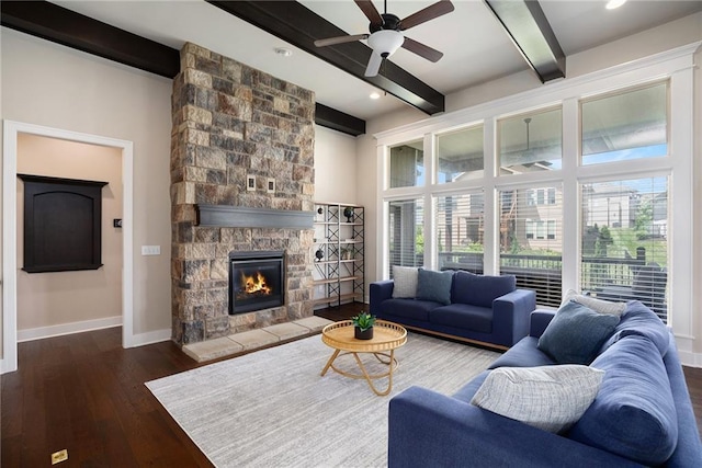 25072 W 114th Ct, Olathe, KS 66061 - living room with beam ceiling, a ceiling fan, wood finished floors, and a stone fireplace