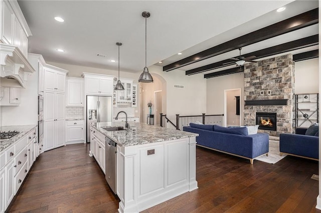 25072 W 114th Ct, Olathe, KS 66061 - kitchen featuring appliances with stainless steel finishes, dark wood-style floors, ceiling fan, beam ceiling, and white cabinets