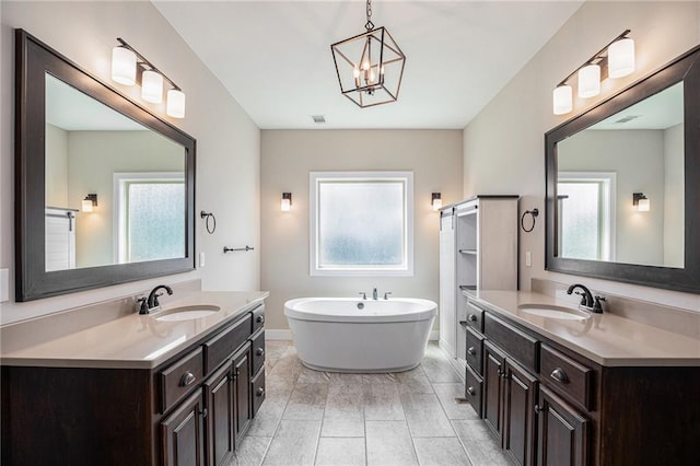 25072 W 114th Ct, Olathe, KS 66061 - bathroom with plenty of natural light, a freestanding bath, and two vanities