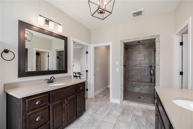 25072 W 114th Ct, Olathe, KS 66061 - bathroom featuring two vanities, a stall shower, and a chandelier