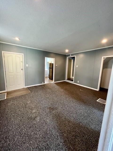 2022 Jules St, Saint Joseph, MO 64501 - unfurnished room featuring ornamental molding, carpet, and a textured ceiling