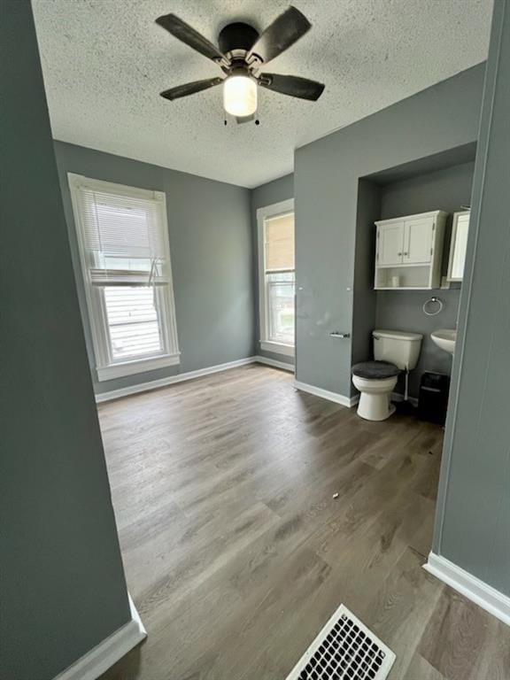 2022 Jules St, Saint Joseph, MO 64501 - unfurnished bedroom featuring wood finished floors, a textured ceiling, and ceiling fan
