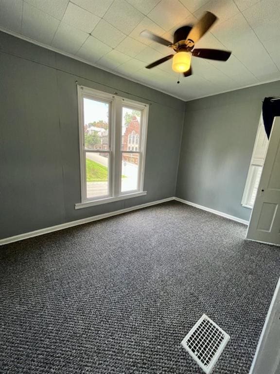 2022 Jules St, Saint Joseph, MO 64501 - spare room featuring dark carpet and ceiling fan