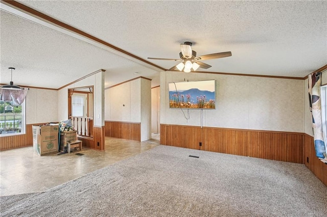 507 NW 165th Rd, Centerview, MO 64019 - carpeted empty room with a wainscoted wall, wooden walls, a textured ceiling, and ceiling fan