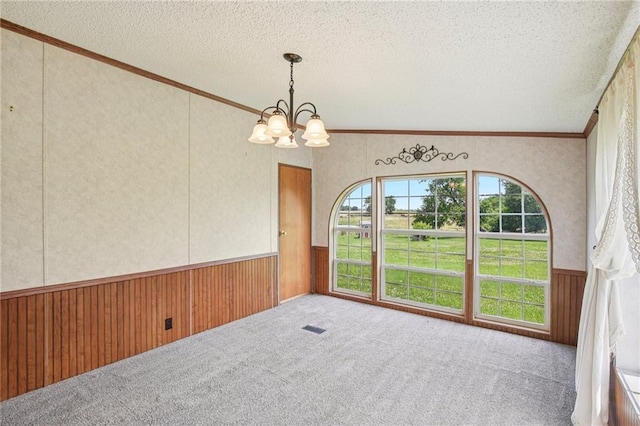 507 NW 165th Rd, Centerview, MO 64019 - unfurnished room with a wainscoted wall, a chandelier, a textured ceiling, crown molding, and carpet flooring