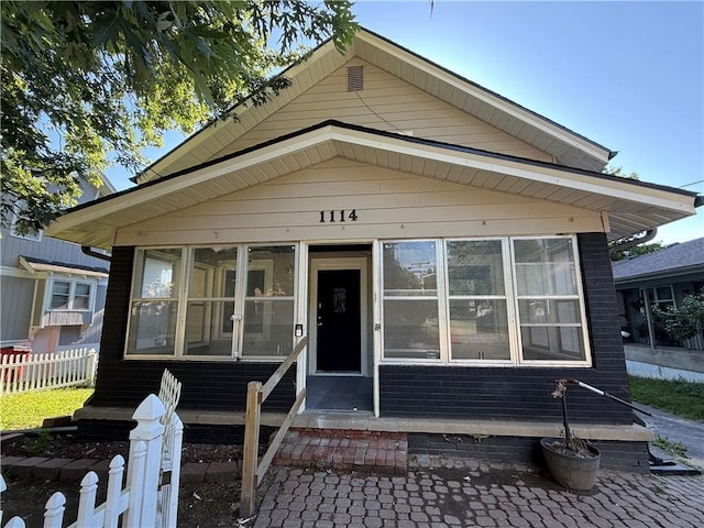 1114 N Liberty St, Independence, MO 64050 - shotgun-style home featuring a sunroom