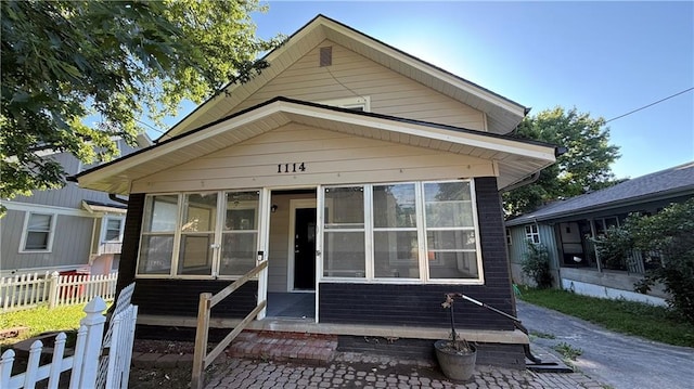1114 N Liberty St, Independence, MO 64050 - shotgun-style home with a sunroom