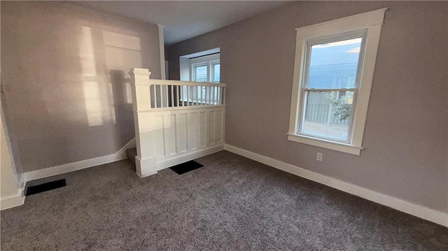 1114 N Liberty St, Independence, MO 64050 - unfurnished room with dark colored carpet and baseboards