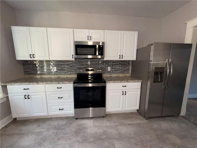 1114 N Liberty St, Independence, MO 64050 - kitchen featuring appliances with stainless steel finishes, white cabinets, and backsplash