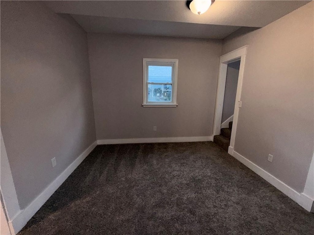 1114 N Liberty St, Independence, MO 64050 - empty room featuring dark colored carpet and stairs