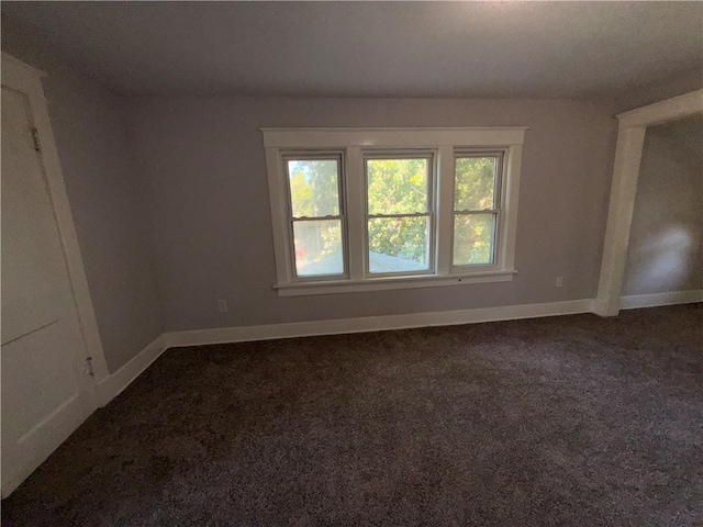 1114 N Liberty St, Independence, MO 64050 - unfurnished room featuring dark colored carpet and baseboards