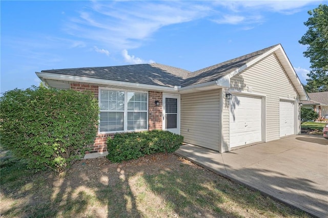 212 NW Parker Dr, Grain Valley, MO 64029 - ranch-style house with brick siding, an attached garage, driveway, and a shingled roof