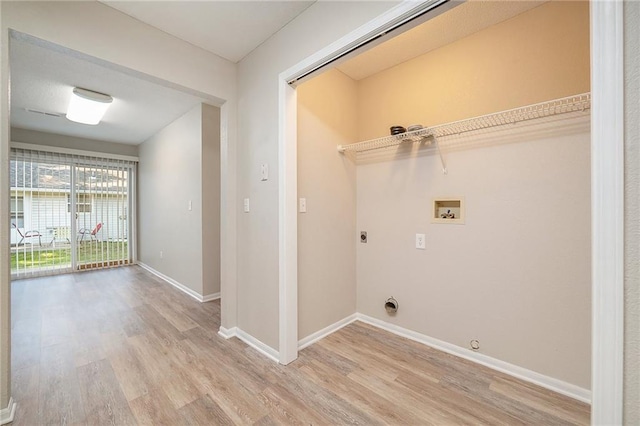 212 NW Parker Dr, Grain Valley, MO 64029 - laundry area featuring hookup for an electric dryer, gas dryer hookup, light wood-style floors, and hookup for a washing machine