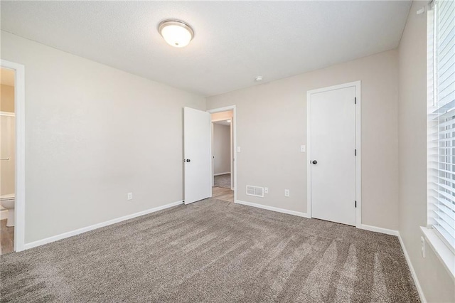 212 NW Parker Dr, Grain Valley, MO 64029 - unfurnished bedroom featuring carpet and ensuite bathroom