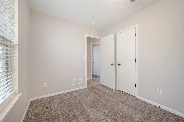 212 NW Parker Dr, Grain Valley, MO 64029 - unfurnished bedroom featuring carpet floors and baseboards