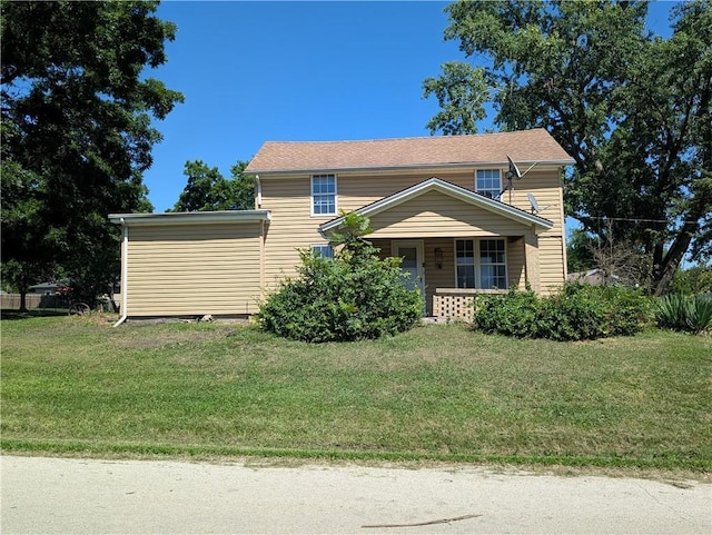 707 N 4th St, La Cygne, KS 66040 - view of front of property featuring a front lawn and covered porch