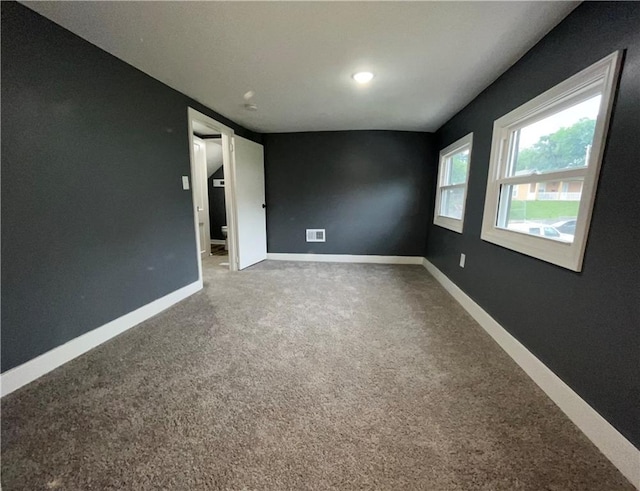1027 Ohio Ave, Kansas City, KS 66102 - carpeted empty room with baseboards and recessed lighting