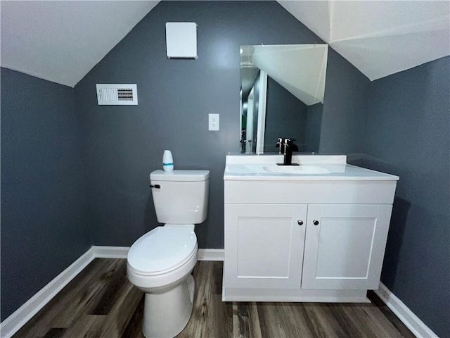 1027 Ohio Ave, Kansas City, KS 66102 - bathroom with wood finished floors, vanity, and vaulted ceiling