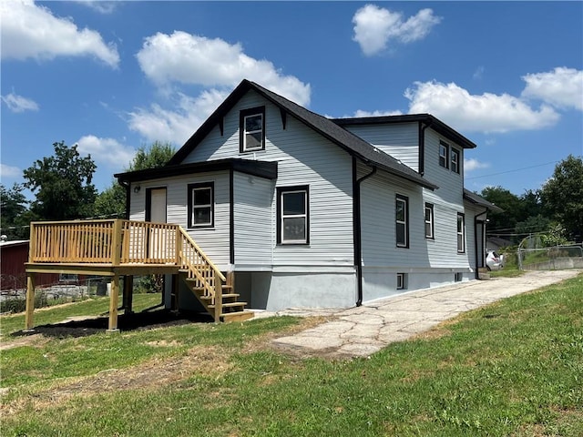 1027 Ohio Ave, Kansas City, KS 66102 - rear view of house featuring a deck, a yard, and stairway