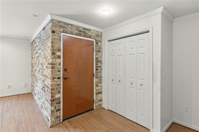 5006 Baltimore Ave Unit 205, Kansas City, MO 64112 - foyer featuring wood finished floors, ornamental molding, and brick wall