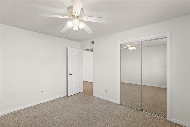 5006 Baltimore Ave Unit 205, Kansas City, MO 64112 - unfurnished bedroom featuring carpet, a closet, and a ceiling fan