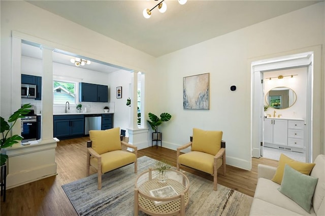 3808 Anderson Ave, Kansas City, MO 64123 - living room with decorative columns and wood finished floors