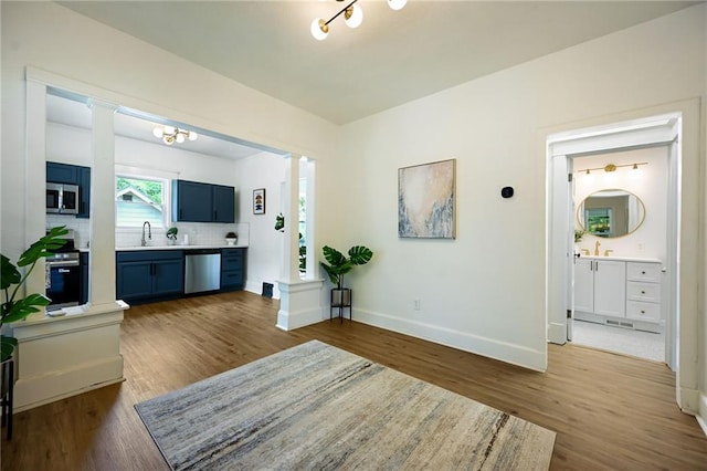 3808 Anderson Ave, Kansas City, MO 64123 - living area with decorative columns and wood finished floors