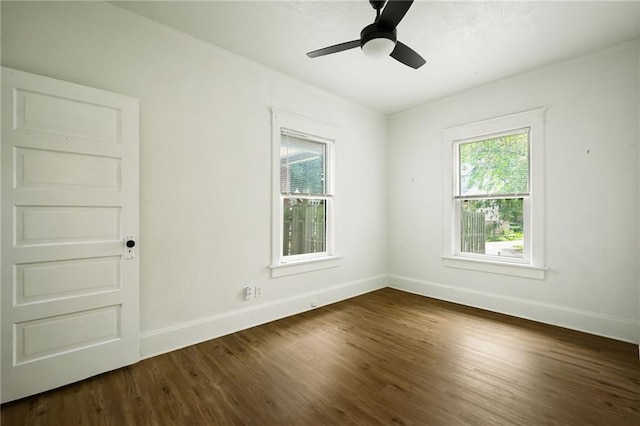 3808 Anderson Ave, Kansas City, MO 64123 - empty room with plenty of natural light, dark wood-style flooring, and a ceiling fan