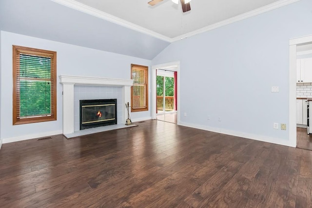 1401 NE Weddle Ln, Lees Summit, MO 64086 - unfurnished living room with ceiling fan, wood finished floors, a tile fireplace, vaulted ceiling, and crown molding