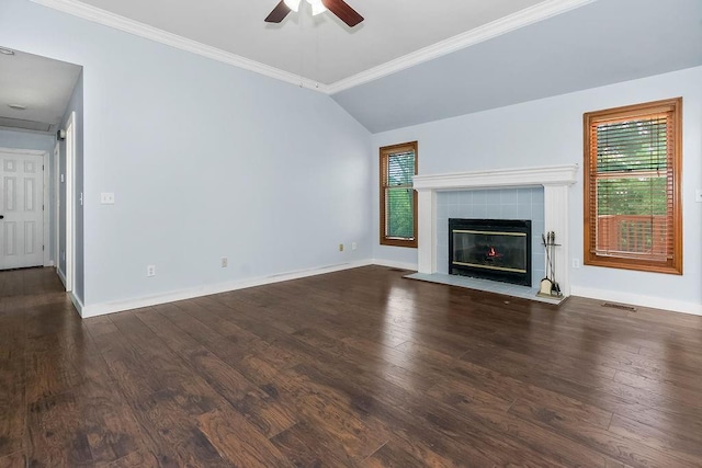 1401 NE Weddle Ln, Lees Summit, MO 64086 - unfurnished living room featuring ceiling fan, plenty of natural light, dark wood-type flooring, a tiled fireplace, and ornamental molding