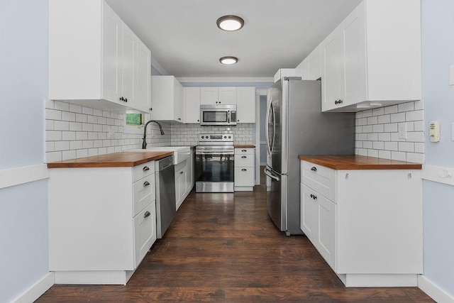 1401 NE Weddle Ln, Lees Summit, MO 64086 - kitchen featuring appliances with stainless steel finishes, wooden counters, tasteful backsplash, and dark wood-style floors