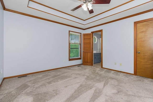 1401 NE Weddle Ln, Lees Summit, MO 64086 - carpeted spare room with crown molding, a ceiling fan, and a tray ceiling