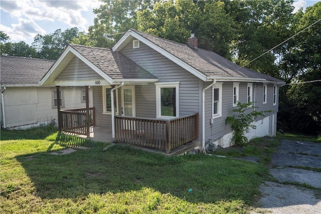 600 Ridgeview Ave, Kansas City, KS 66103 - view of front facade with a chimney, a front lawn, a shingled roof, and a porch