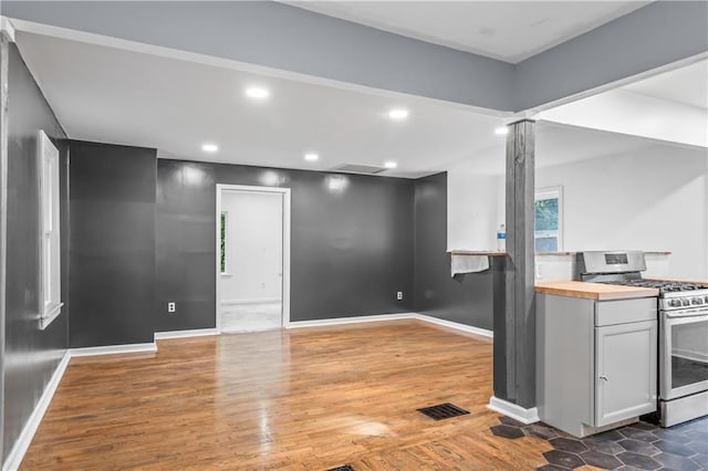 600 Ridgeview Ave, Kansas City, KS 66103 - kitchen featuring stainless steel range with gas cooktop, butcher block counters, wood finished floors, recessed lighting, and ornate columns