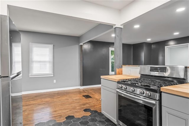 600 Ridgeview Ave, Kansas City, KS 66103 - kitchen with stainless steel appliances, butcher block countertops, recessed lighting, wood finished floors, and decorative backsplash
