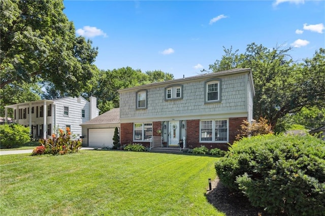 7211 Goodman St, Overland Park, KS 66204 - colonial house with a garage, a front lawn, and brick siding