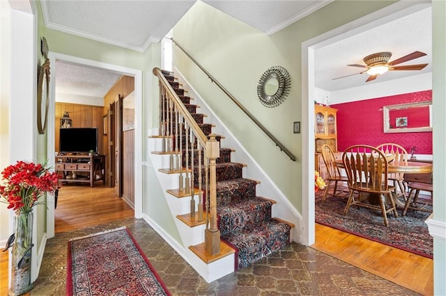 7211 Goodman St, Overland Park, KS 66204 - stairs featuring a textured ceiling, ornamental molding, and ceiling fan