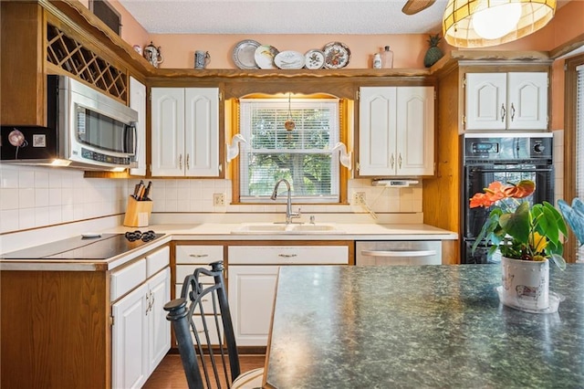 7211 Goodman St, Overland Park, KS 66204 - kitchen featuring black appliances, white cabinetry, and decorative backsplash