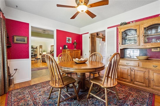 7211 Goodman St, Overland Park, KS 66204 - dining area with wood finished floors, ceiling fan, and a textured ceiling