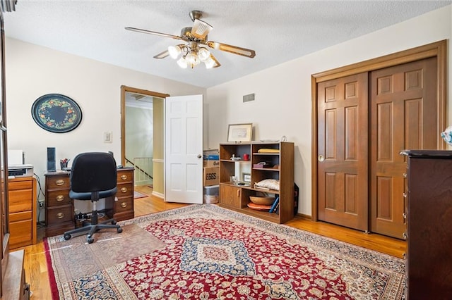 7211 Goodman St, Overland Park, KS 66204 - office space with wood finished floors, a ceiling fan, and a textured ceiling