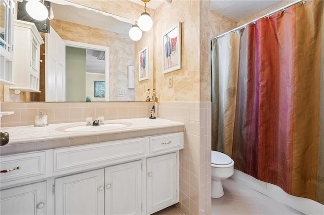 7211 Goodman St, Overland Park, KS 66204 - bathroom with tile walls, vanity, tile patterned floors, and curtained shower