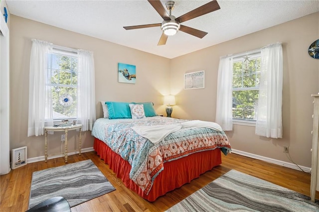 7211 Goodman St, Overland Park, KS 66204 - bedroom featuring multiple windows, wood finished floors, and ceiling fan