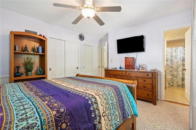7211 Goodman St, Overland Park, KS 66204 - bedroom with two closets, light colored carpet, connected bathroom, and a ceiling fan