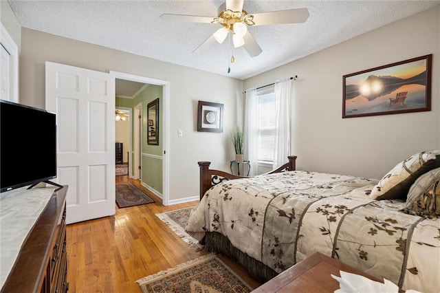 7211 Goodman St, Overland Park, KS 66204 - bedroom with light wood-type flooring, a textured ceiling, and a ceiling fan