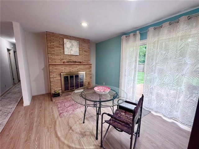 1012 Meadowbrook Rd E, Iola, KS 66749 - living room featuring wood finished floors and a brick fireplace