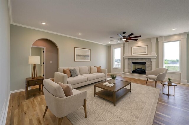 24108 W 67th Ter, Shawnee, KS 66226 - living area with light wood-style floors, ceiling fan, arched walkways, ornamental molding, and recessed lighting