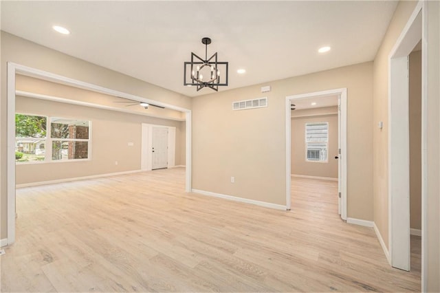 4036 Benton Blvd, Kansas City, MO 64130 - unfurnished room featuring recessed lighting, a chandelier, and light wood-style flooring